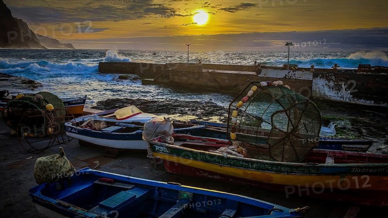 Harbour with colorful fishing boats and setting sun over the stormy sea, romantic harbor scene, Ponta do Sol, Santo Antao, Cabo Verde, Cape Verde, Cape Verde
