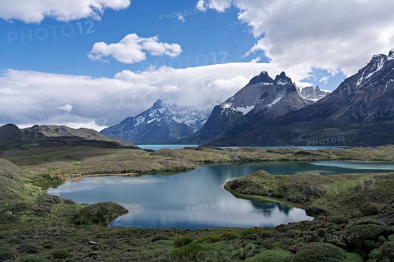 Cuernos del Paine with offshore lagoons and Lake Nordenskjöld, snow-capped granite peaks under clouds, Torres del Paine National Park, Patagonia, Chile