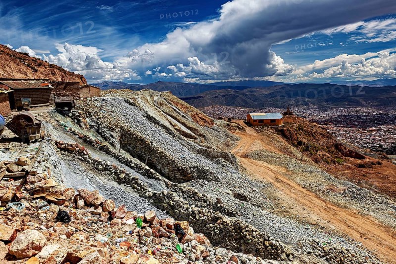Falling scree slope with buildings and wide clouds on the horizon, The silver mines near Potosi on Cerro Rico in Bolivia