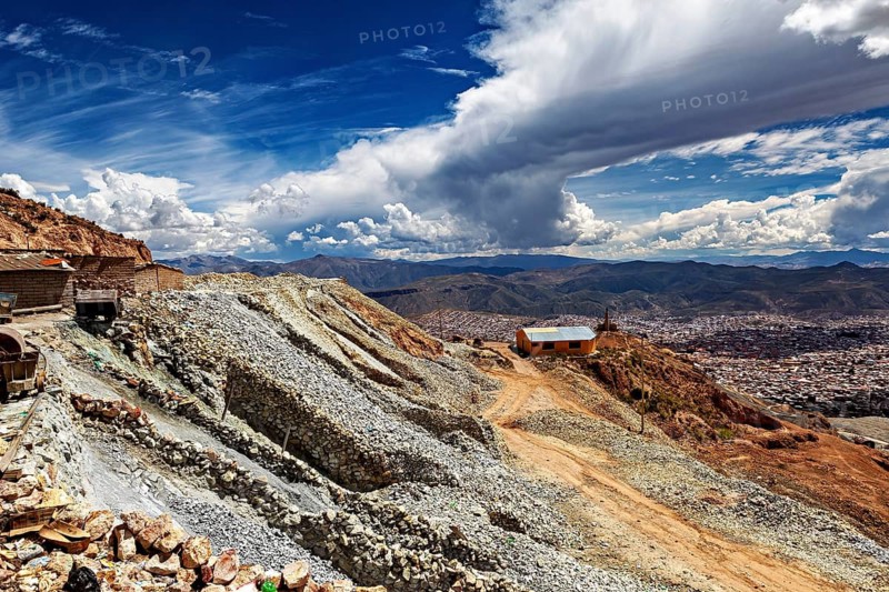 Barren mountainside landscape with buildings and dramatic sky in the background, The silver mines near Potosi on Cerro Rico in Bolivia