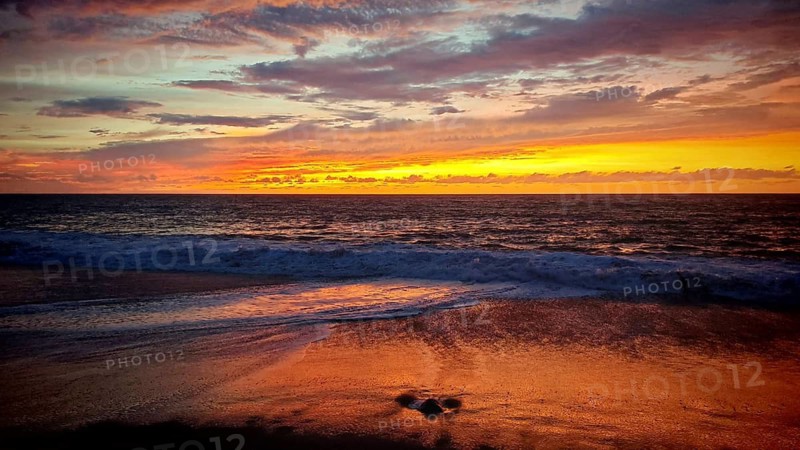 Romantic, mystical sunset with intense shades of red over the sandy beach and light swell, Tarrafal de Monte Trigo, Santo Antao, Cabo Verde, Cape Verde, Cape Verde
