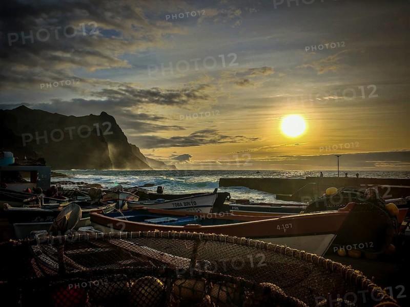 Several boats in a harbor with setting sun over the sea, fish net, golden waves frame the scene, romantic, sunset, harbor scene, Ponta do Sol, Santo Antao, Cabo Verde, Cape Verde, Cape Verde