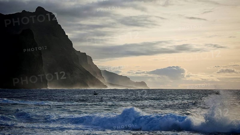 Evening light, twilight, dramatic coastal landscape, steep cliffs, silhouette of mountain formation, with moving sea, high waves and threatening clouds, Ponta do Sol, Santo Antao, Cabo Verde, Cape Verde, Cape Verde