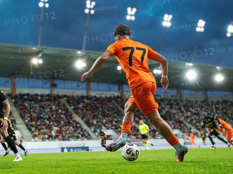 Football player dribbles during the match at the stadium in Lubin, Poland
