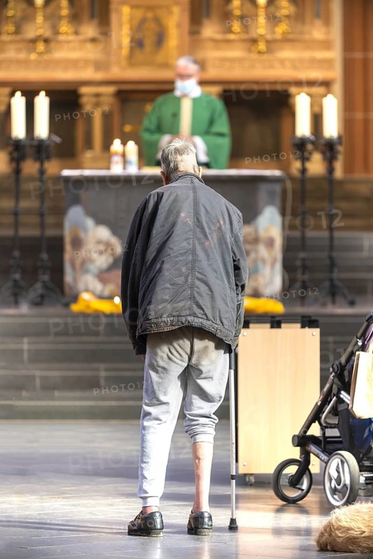 A mentally confused homeless man in the church, family mass with blessing of animals in St Agnes, Agneskirche, Cologne, North Rhine-Westphalia, Germany