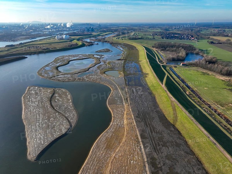 Haltern-Marl, North Rhine-Westphalia, Germany - Lippe, flood protection in the Haltern-Lippramsdorf-Marl area (HaLiMa) . Flood protection on the River Lippe by relocating the dyke and thus extending the floodplain. On the right, the completed floodplain north, the north dyke. Work is still underway on the south dyke. Marl Chemical Park in the back