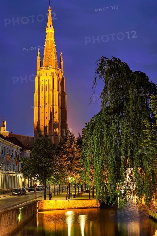 Church of Our Lady and canal illuminated in the night. Brugge Bruges, Belgium