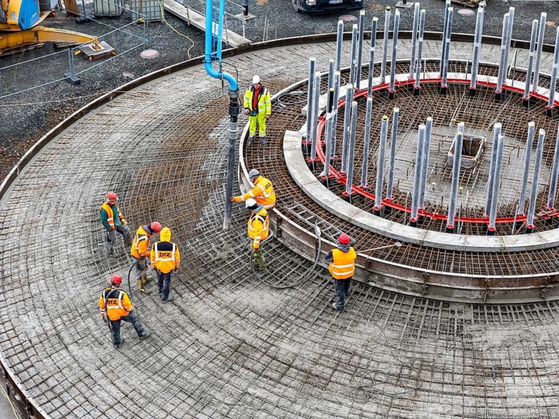 Concreting, concreting the foundation of a wind turbine, more than 600 cubic meters of concrete will be pumped into the foundation for over 7 hours, over 100 tons of reinforcing steel have been used, the wind turbine will have a hub height of 160 meters, part of a new wind farm in Sauerland, near Balve, North Rhine-Westphalia, Germany