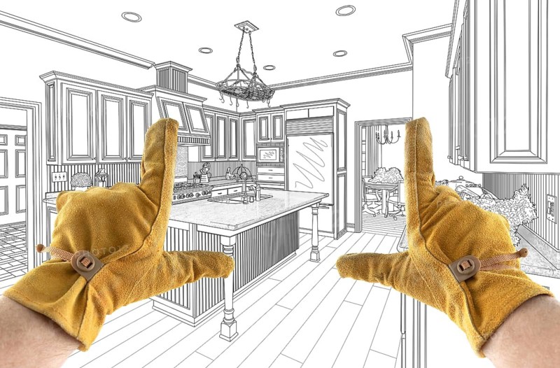 Male Contractor Hands Framing Over Custom Kitchen Design Drawing