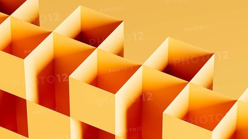This graphic features an arrangement of 3D cubes in bright orange tones, forming an abstract composition against a seamless gradient backdrop