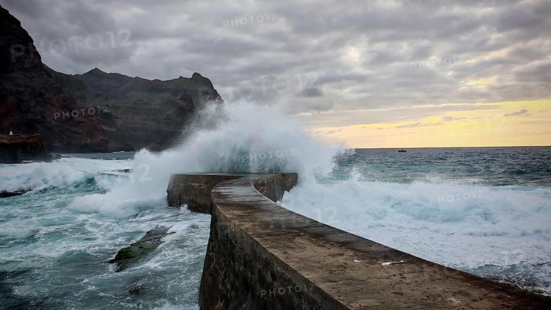Coastal pier surrounded by gigantic waves and dramatic ocean vibes in the evening light, Ponta do Sol, Santo Antao, Cabo Verde, Cape Verde