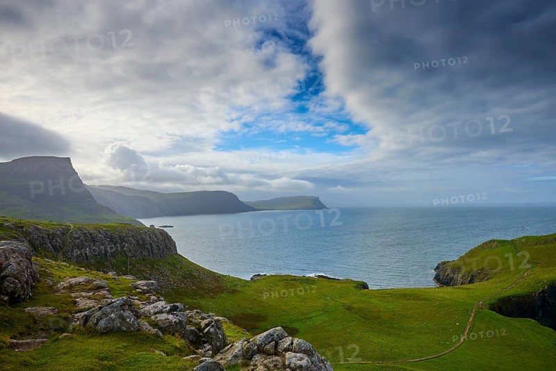 Rocky coastal landscape with cloudy sky and green grass, Waterstein Head, Waterstein, Isle of Skye, Scotland, United Kingdom, Great Britain