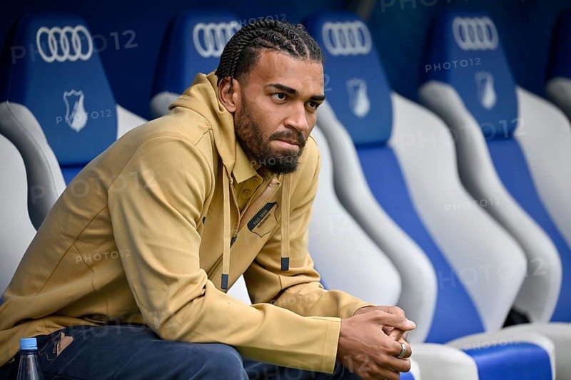 Kevin Akpoguma TSG 1899 Hoffenheim (25) sits thoughtfully on the substitutes' bench Bundesliga football, PreZero Arena, Sinsheim, Baden-Württemberg, Germany