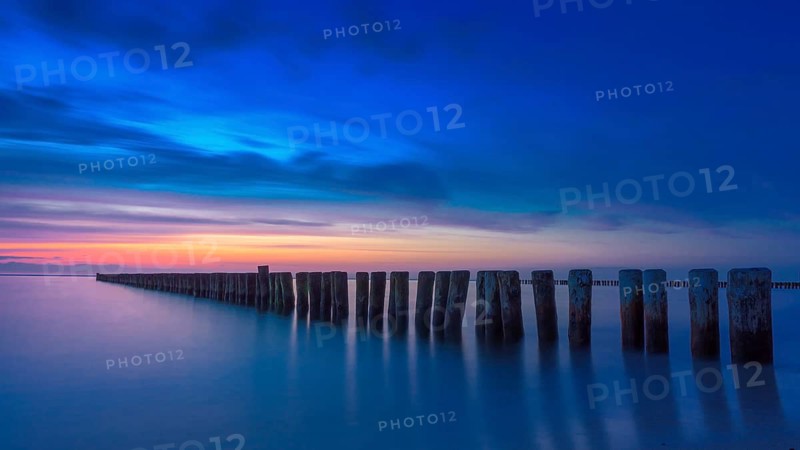 Sunset at beach of Baltic sea spa Nienhagen with breakwater groin, Baltic Sea, Mecklenburg-Western Pomerania, Germany
