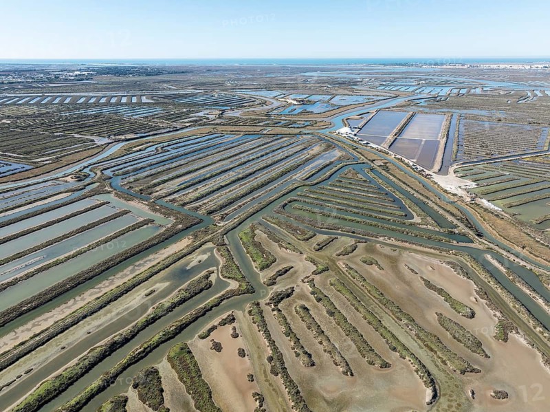 Saline ponds at the salt works near Chiclana de la Frontera. Aerial view. Drone shot. Bahía de Cádiz Nature Reserve, Cádiz province, Andalusia, Spain