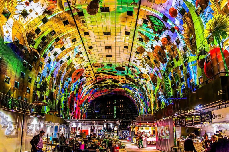 Markthal from 2014, offers over 100 food stalls and delicatessens with spectacular ceiling fresco cornucopia, Horn of Plenty by Arno Coenen and Iris Roskam, Rotterdam, the Netherlands