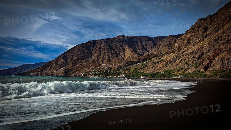 Beach, volcanic sand, waves breaking on the coast against a mountain backdrop under dramatic skies, hiking, Tarrafal de Monte Trigo, Santo Antao, Cabo Verde, Cape Verde, Cape Verde