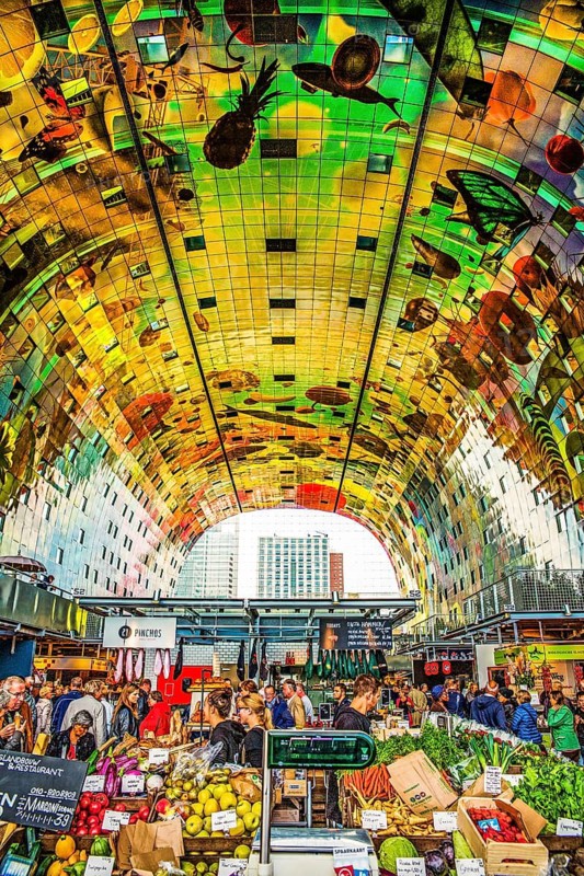 Markthal from 2014, offers over 100 food stalls and delicatessens with spectacular ceiling fresco cornucopia, Horn of Plenty by Arno Coenen and Iris Roskam, Rotterdam, the Netherlands