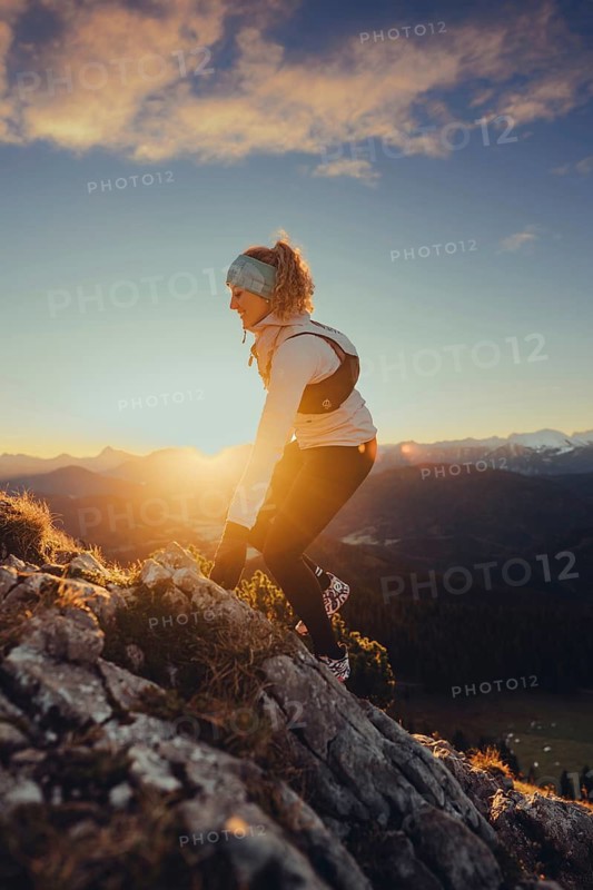 Trail running in autumn on the Jochberg on Lake Walchensee against the wonderful backdrop of the Alps, Bavaria, Germany