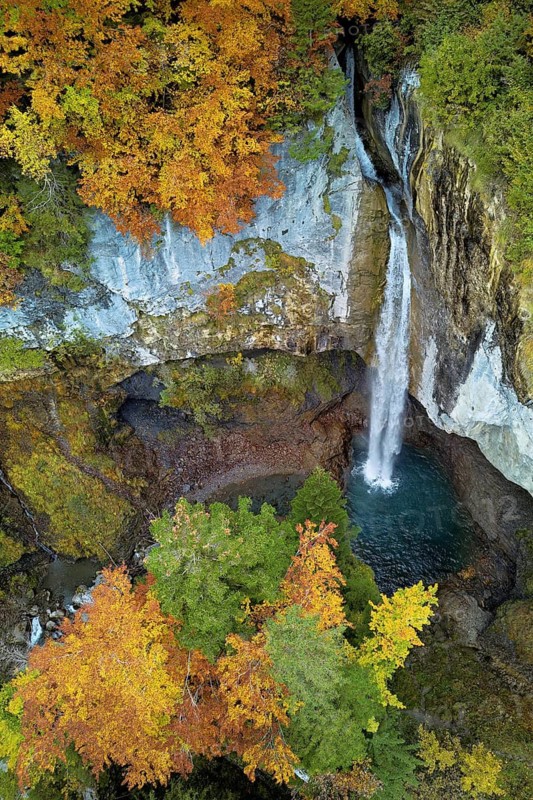 Aerial view of Berglistüber waterfall in autumn-colored surroundings, Linthal, Klausenpass, Canton of Glarus, Switzerland