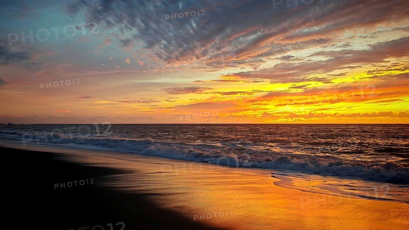 Romantic sunset over the sea with warm colors and calm water, Tarrafal de Monte Trigo, Santo Antao, Cabo Verde, Cape Verde, Cape Verde
