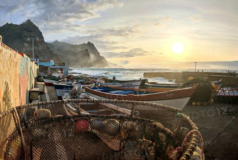 Coastal view with nets, baskets and fishing boats at sunset, wall with graffiti, romantic harbor scene, Ponta do Sol, Santo Antao, Cabo Verde, Cape Verde, Cape Verde