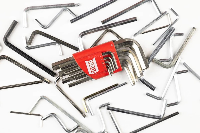 Various L-shaped Allen wrenches scattered on a bright surface