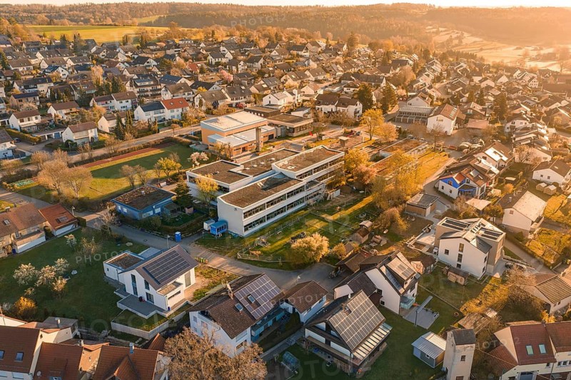 Residential area with school buildings and solar panels, surrounded by autumn nature, Schlehengäuschule, Gechingen, Hecken and Gäu region, Calw district, Germany