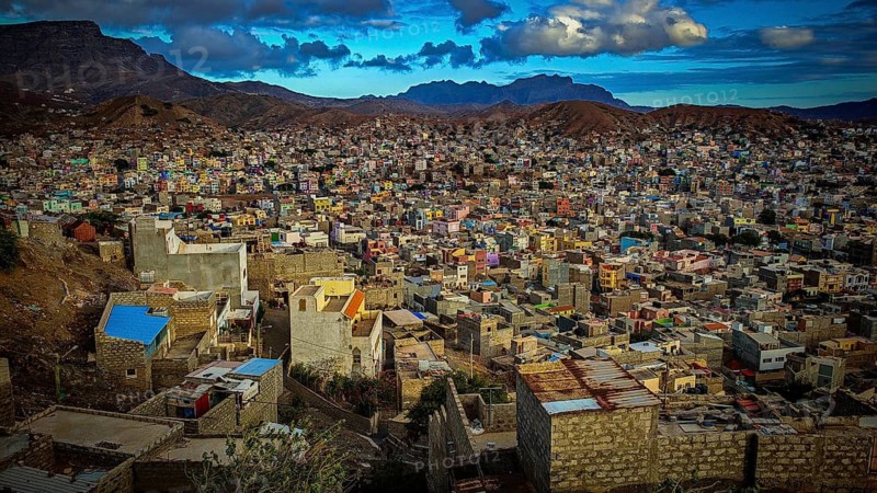 Panorama, view of Mindelo from above, colorful city on hills with mountains in the background under cloudy sky, dusk, Mindelo, Sao Vicente, Cabo Verde, Cape Verde, Cape Verde