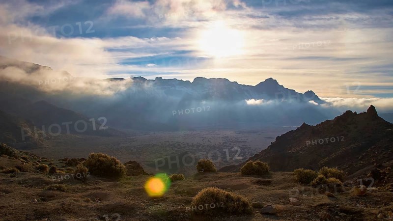 Dramatic mountain landscape with brilliant light through cloud cover and green vegetation, Teide, Parque Nacional del Teide, Teide National Park, volcano, volcanism, UNESCO World Heritage Site, Tenerife, Canary Islands, Spain