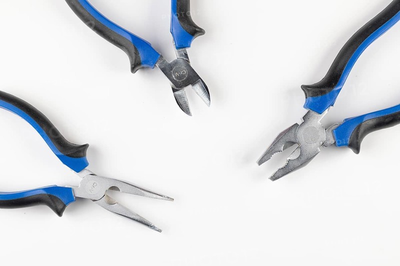 Three pliers grouped with handles in blue and black on a white background