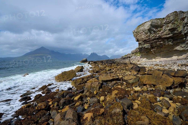 Rocky coastal landscape with waves and mountains under a cloudy sky, Elgol Beach, Elgol, Isle of Skye, Scotland, United Kingdom, Great Britain
