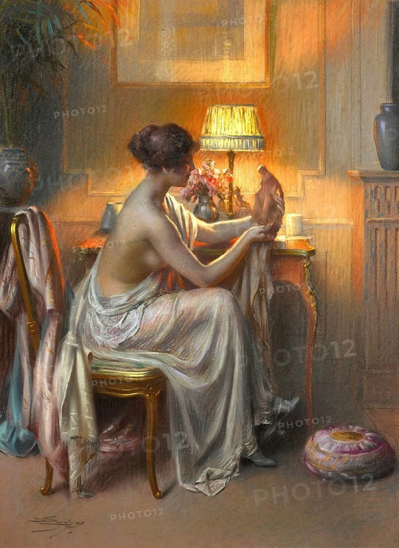 La Connaisseuse, The Connoisseur, is a well-known painting by the French painter Delphin Enjolras (1857-1945) . A young woman in an elegant interior, attentively contemplating an object, a work of art or a small figure, illustration, reproduction of a painting. Authentic, File restored for optimal use, Exact date of original unknown, Historic, A woman sits in front of a table with a cat in a quiet, softly lit night environment