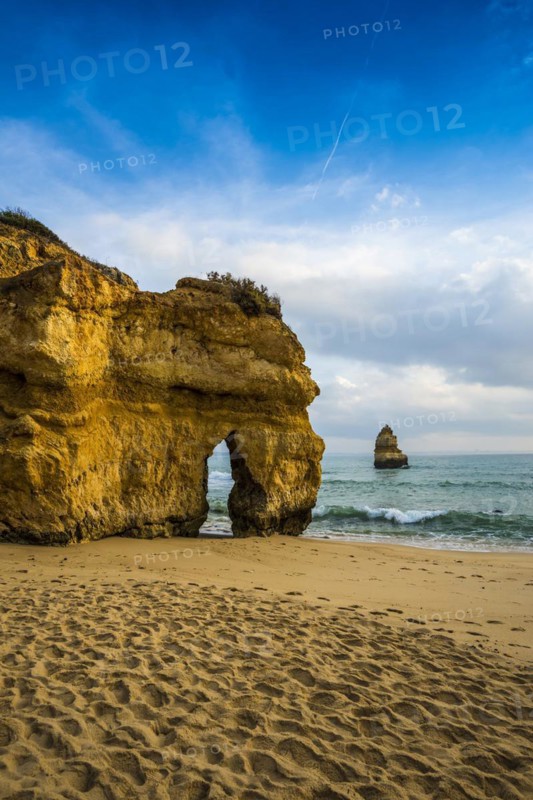 Rocky coast with beach and red rocks, Praia do Camilo, Lagos, Algarve, Portugal
