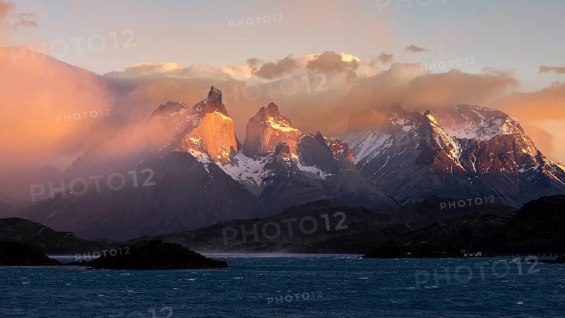 Cuernos del Paine in morning light with clouds and Lake Pehoé in the foreground, Torres del Paine National Park, Patagonia, Chile