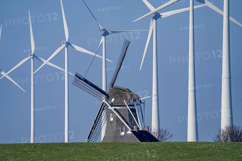 Poldermolen De Goliath windmill stands between the high-tech wind turbines in Eemshaven, historic windmill from around 1882, rebuilt and rebuilt several times, Westereems wind farm, Groningen province, Netherlands