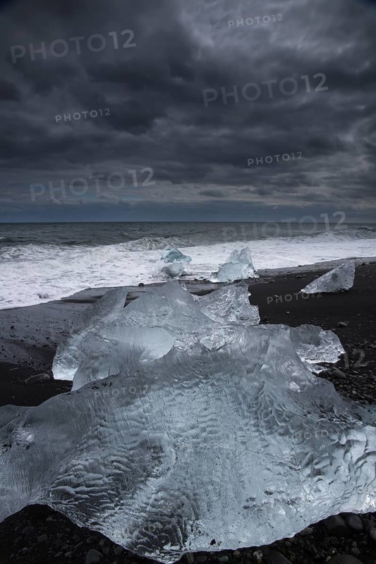 Little icebergs and crushed ice on the black beach at Joekulsarlon glacial lake