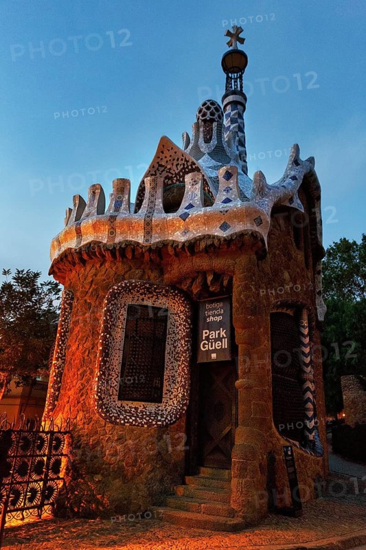 House with tower and souvenir shop at dawn, sign with inscription Park Güell, entrance at sunrise, Gracia, Barcelona, Spain