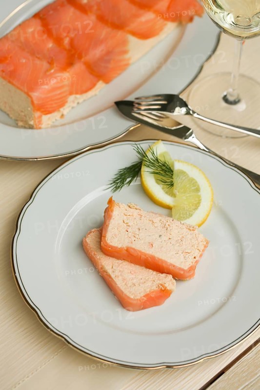 Southern German cuisine, salmon trout terrine arranged on a plate, salmon terrine with trout fillets, fish dish, salmon fillets, smoked salmon, starter, fine dining, Sunday crockery with gold rim, grandma's service, lemons, dill, fish cutlery, food photography, studio, Germany
