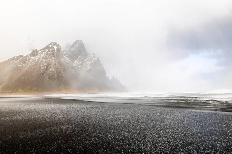 Sleet on black lava sandy beach against mountain backdrop, sea, winter, Stokksnes, Vestrahorn, Klifatindur, Höfn, Iceland, Scandinavia