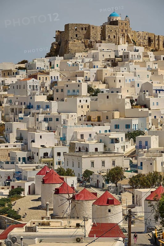 Windmills and white houses on a slope below a stone fortress on a hill, Querini Castle, Chora, Astypalea, Dodecanese, Greek Islands, Greece