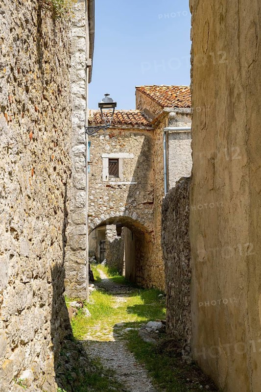 A little road going through the small village Lubenice on a sunny day on the island of Cres, Croatia