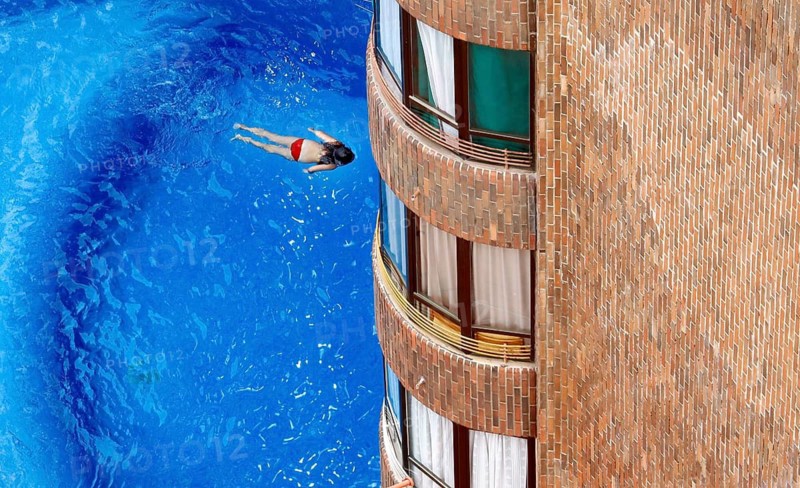 Benidorm, 26.08.09 JE - A girl swims in the pool of a hotel, Spain