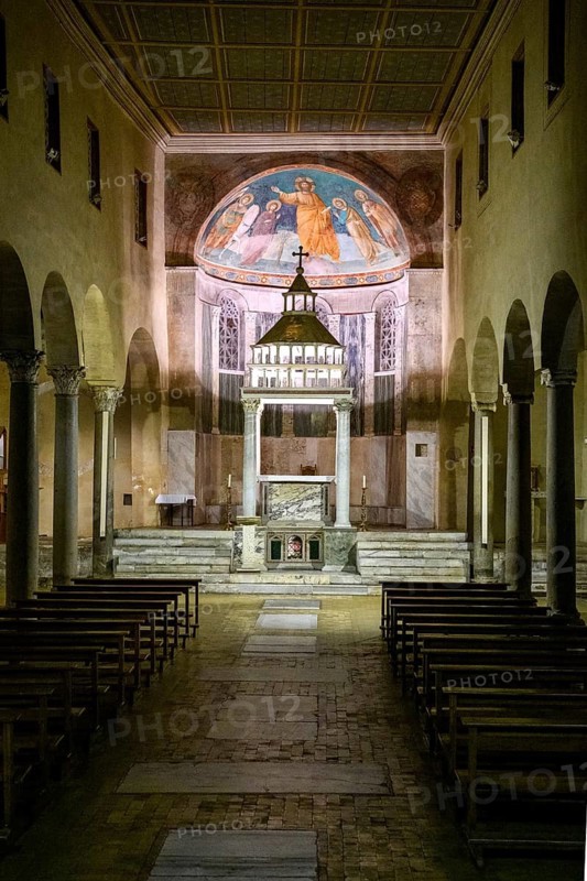Interior view through central nave of altar and apse in three-nave flat-roofed columned basilica 6th century San Giorgio in Velabro in ancient center of Rome, title deaconry, rectorate church, monastery church of regular canon of the Order of the Holy Cross, Forum Boarium, Rome, Italy