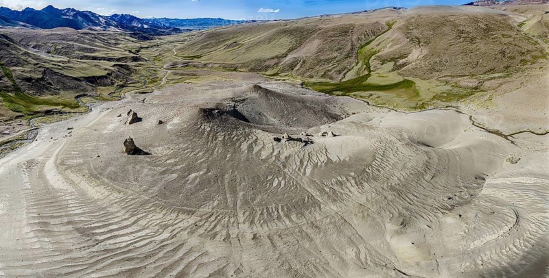 Road Ruta 41, gravel road, arid landscape, Mt. Cerro Boleadoras, volcano-shaped rock formation, Los Antiguos - Paso Roballo, aerial view, Argentina