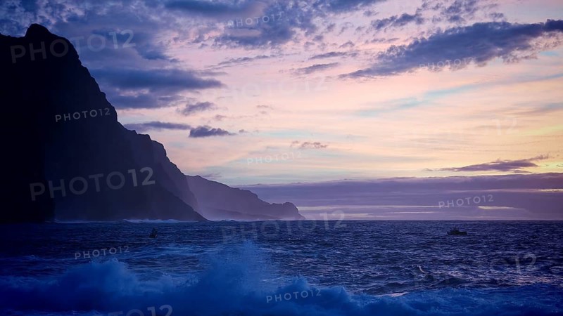 Dusk at sea with cliffs and calm waves in shades of blue and purple, Ponta do Sol, Santo Antao, Cabo Verde, Cape Verde