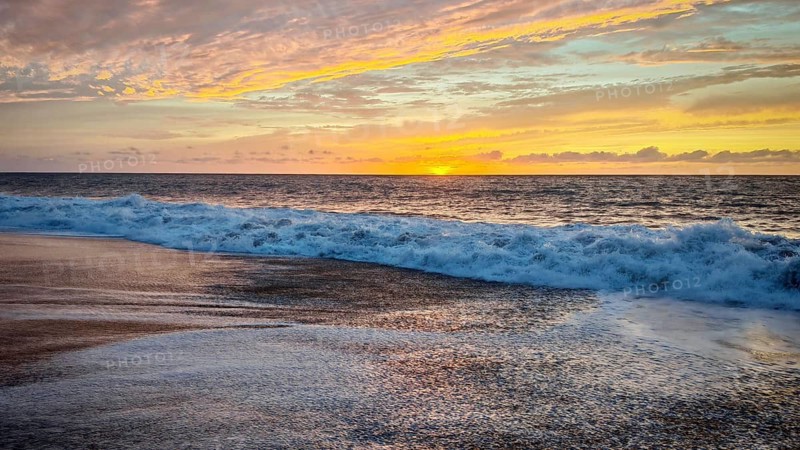 Soft waves on the beach at sunset with orange sky over the sea, Tarrafal de Monte Trigo, Santo Antao, Cabo Verde, Cape Verde, Cape Verde