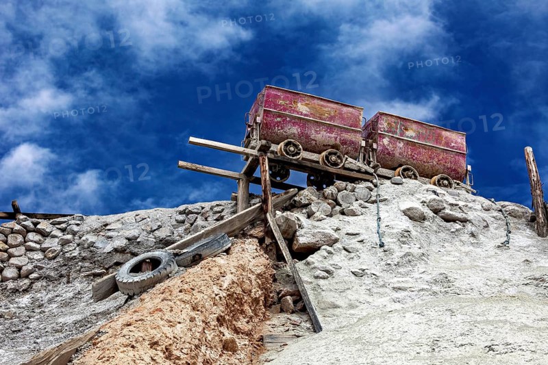 Abandoned colored wagons on a hill, a dystopian view, The silver mines of Potosi on Cerro Rico in Bolivia