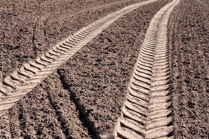 Tractor tracks, agricultural trails at a cultivated field in springtime, farmland near Wesertal, Weser Uplands, Weserbergland, Hesse, Germany