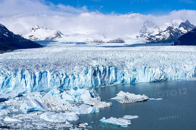 Perito Moreno glacier, breakaway with shimmering blue ice and ice floes on Lake Argentino, snow-capped Andes in the background, Los Glaciares National Park, Santa Cruz Province, Patagonia, Argentina